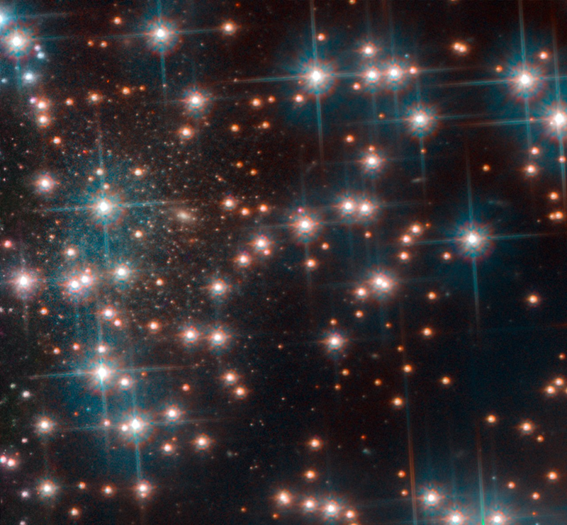 The cluster of small stars along the left of this photo is the newly discovered galaxy, Bedin I, while the large stars in the foreground belong to globular cluster NGC 6752.